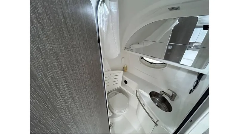 Slide: The Image of 2021 Monterey 335 Sport Yacht bathroom with modern fixtures and compact design. - 18