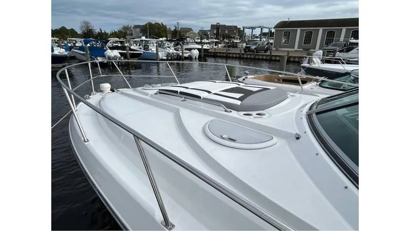 Slide: The Image of 2021 Monterey 335 Sport Yacht docked at marina, showcasing sleek design and spacious deck. - 4