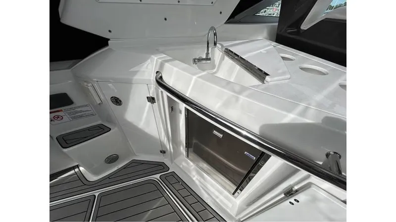 Slide: The Image of 2021 Monterey 335 Sport Yacht interior with sleek kitchenette and modern fixtures. - 7