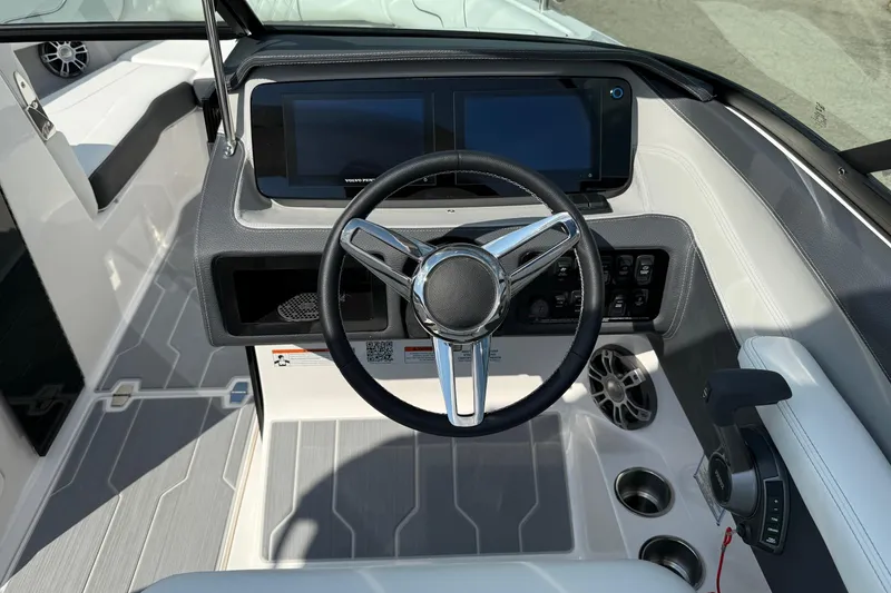 Slide: The Image of 2025 Regal LS6 boat dashboard with steering wheel and digital display. - 12