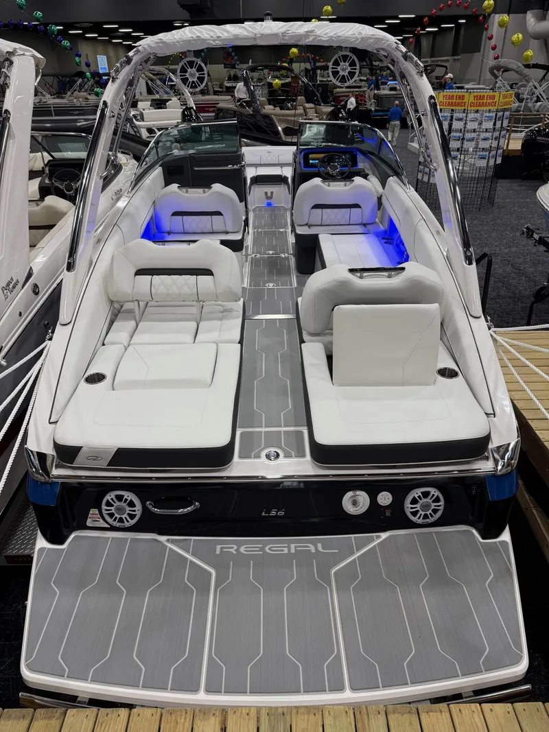 Slide: The Image of Luxurious interior of 2025 Regal LS6 boat with white seating and wooden table. - 5