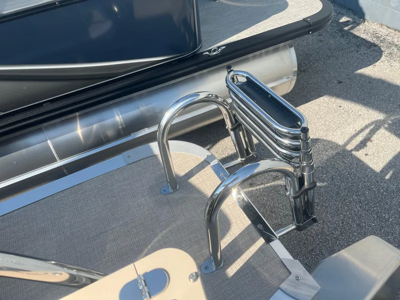 Slide: The Image of 2024 Avalon 2385 LSZ Quad Lounger boat ladder and deck detail. - 10