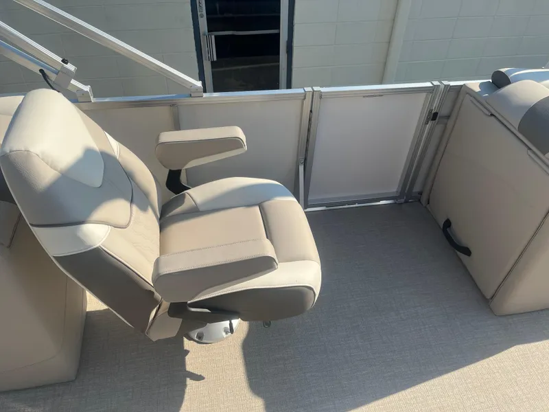 Slide: The Image of 2024 Avalon 2385 LSZ Quad Lounger boat seat, beige upholstery, armrests, and spacious deck. - 9