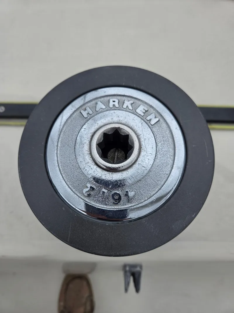 Slide: The Image of 1985 S2 9.1 sailboat with blue and white sail on calm water. - 11