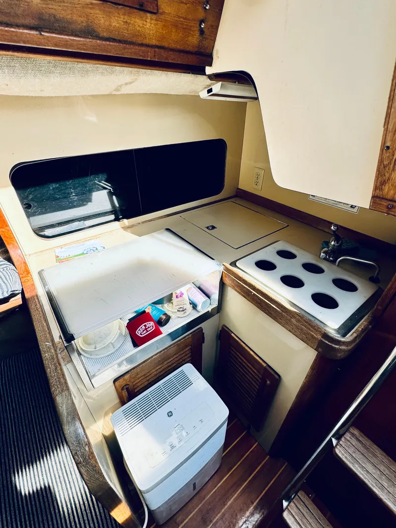 Slide: The Image of Aerial view of S2 9.1 yacht with blue spinnaker, 1985 model. - 9