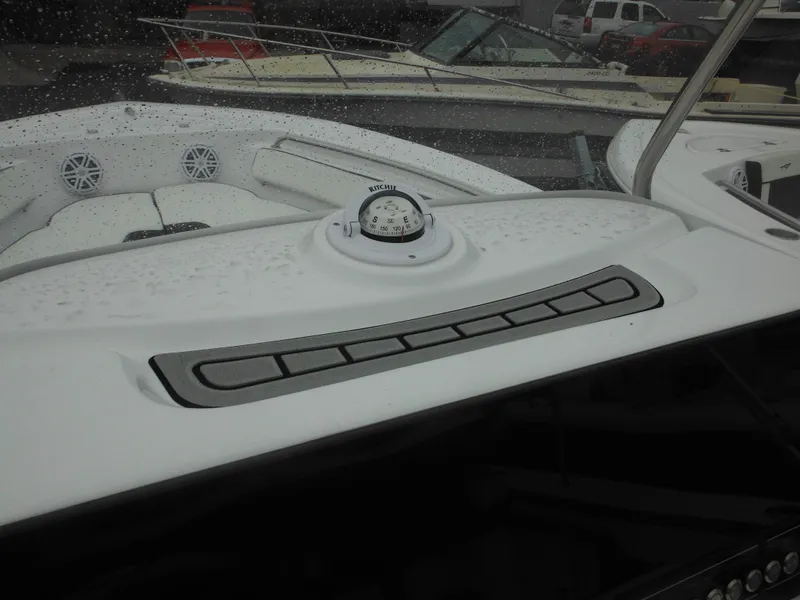 Slide: The Image of 2025 Tidewater 198 CC Adventure boat dashboard with compass and control panel. - 11