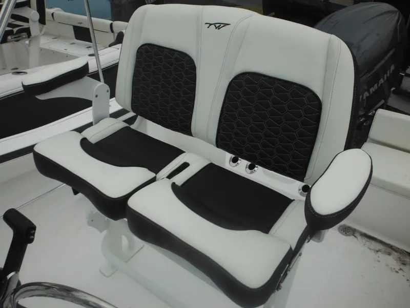 Slide: The Image of 2025 Tidewater 198 CC Adventure boat seating with black and white cushioned design. - 13