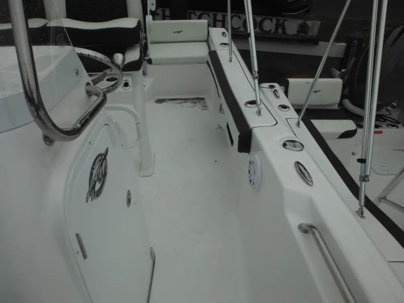 Slide: The Image of 2025 Tidewater 198 CC Adventure boat interior with seating and storage. - 16
