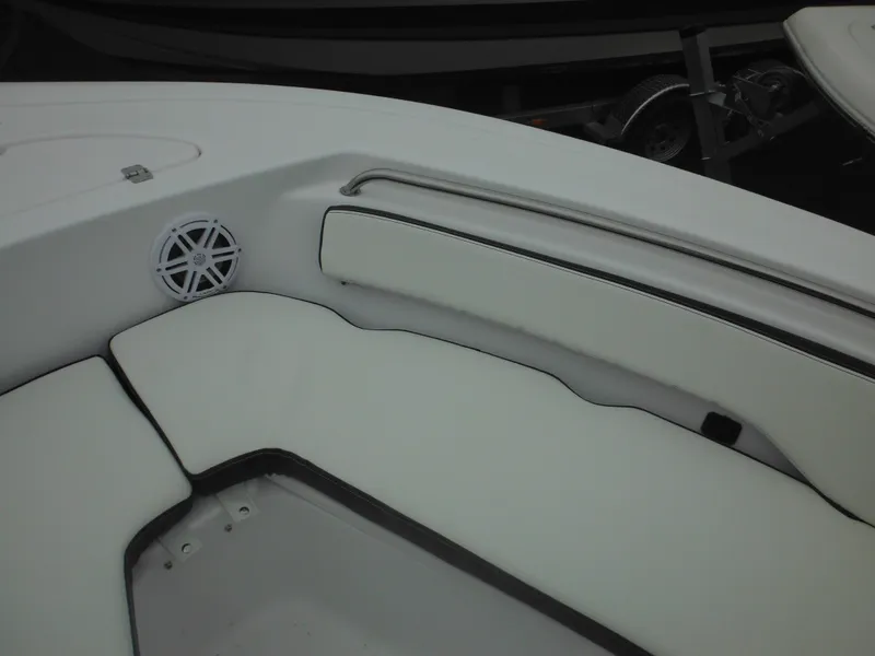 Slide: The Image of 2025 Tidewater 198 CC Adventure boat interior with white cushioned seating and speaker. - 22