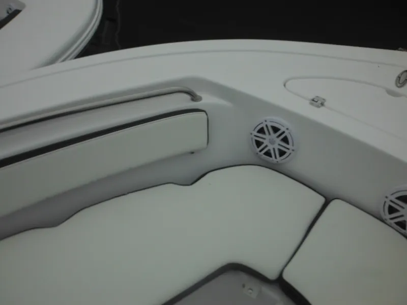 Slide: The Image of 2025 Tidewater 198 CC Adventure boat interior with cushioned seating and speaker. - 23