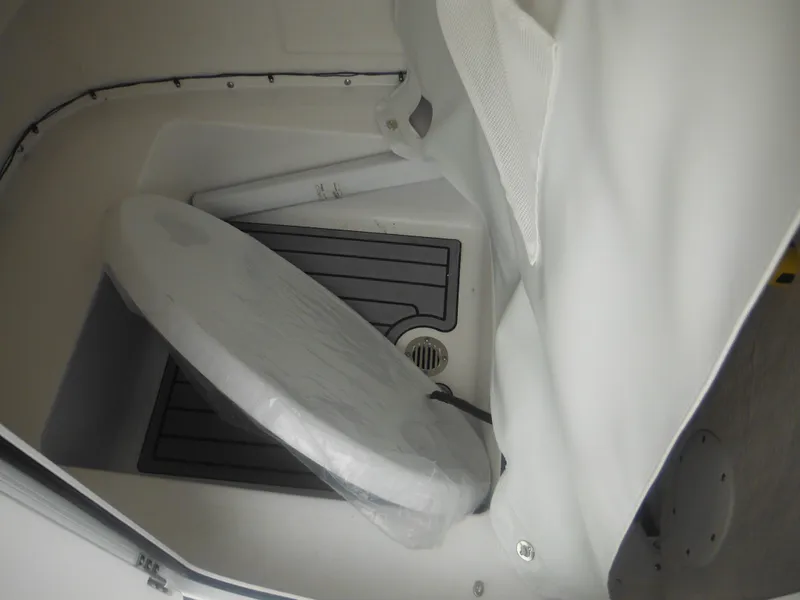 Slide: The Image of 2025 Tidewater 198 CC Adventure boat interior with covered toilet. - 33