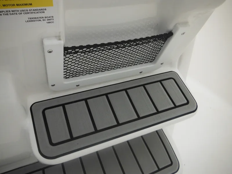 Slide: The Image of 2025 Tidewater 198 CC Adventure boat step with non-slip surface and storage net. - 34