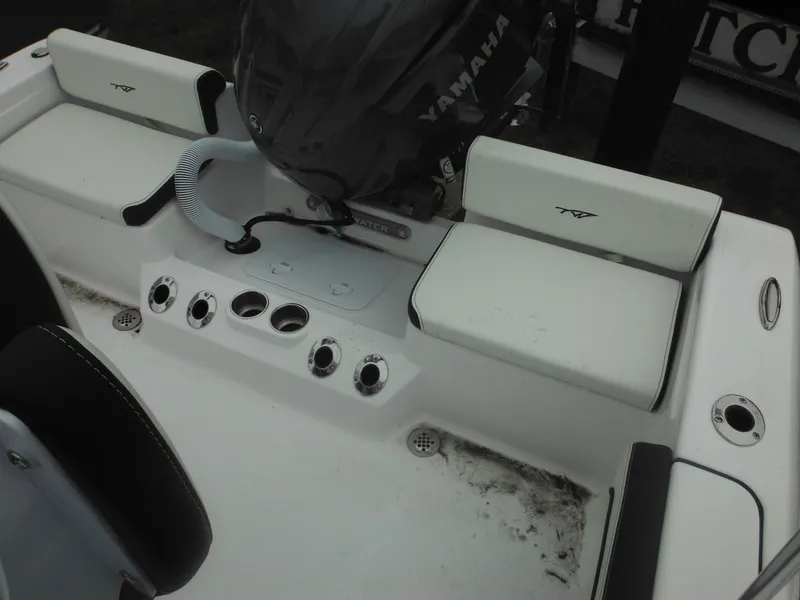 Slide: The Image of 2025 Tidewater 198 CC Adventure boat interior with Yamaha engine, white seating, and control panel. - 35