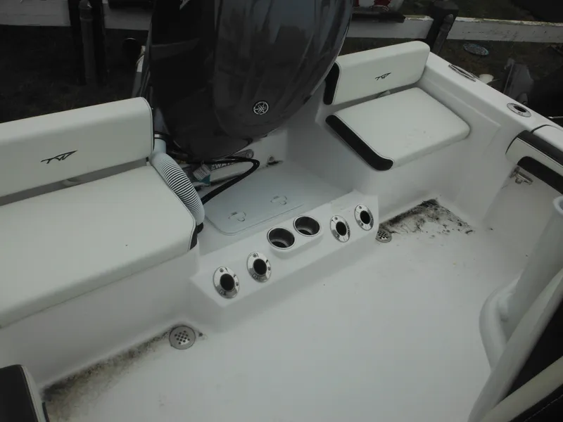 Slide: The Image of 2025 Tidewater 198 CC Adventure boat interior with seating and engine view. - 36