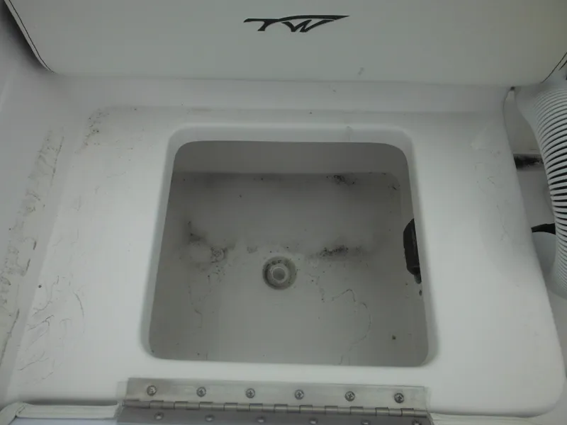 Slide: The Image of Tidewater 198 CC Adventure 2025 boat compartment with TW logo, open and empty. - 37
