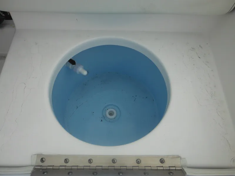 Slide: The Image of Livewell in 2025 Tidewater 198 CC Adventure boat, featuring a blue interior. - 39