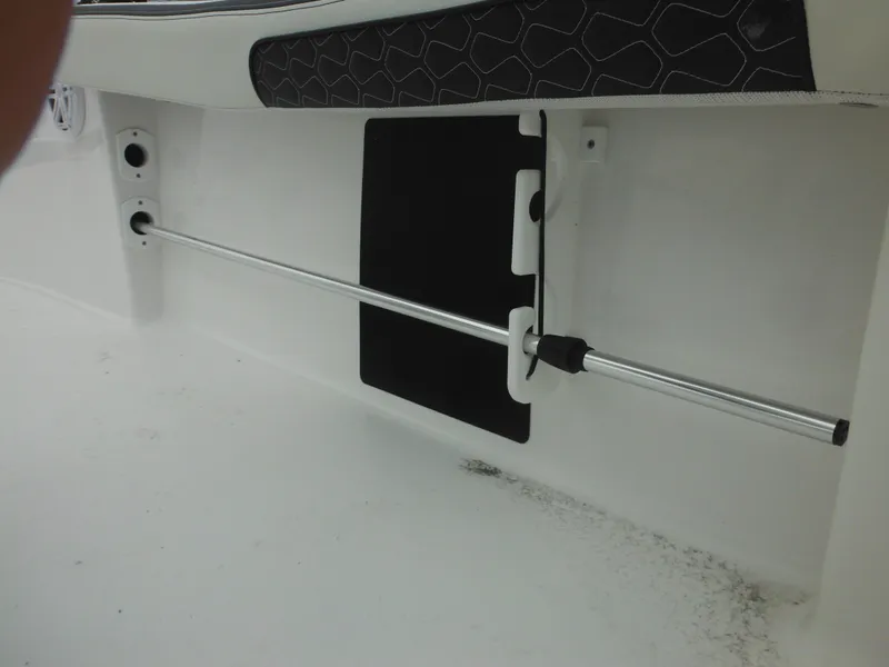 Slide: The Image of 2025 Tidewater 198 CC Adventure boat interior detail with rod holder and cushioned panel. - 44