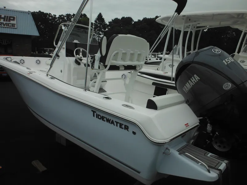 Slide: The Image of 2025 Tidewater 198 CC Adventure boat with Yamaha engine, docked outdoors. - 49