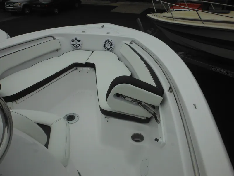Slide: The Image of 2025 Tidewater 198 CC Adventure boat interior with white seating and speakers. - 7