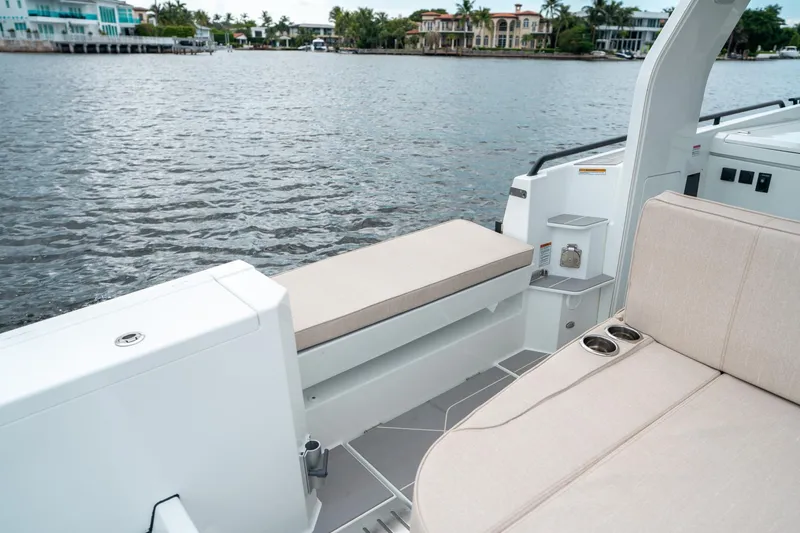Slide: The Image of 2025 Quarken 35 Sport Tourer boat interior with beige seating and waterfront view. - 22