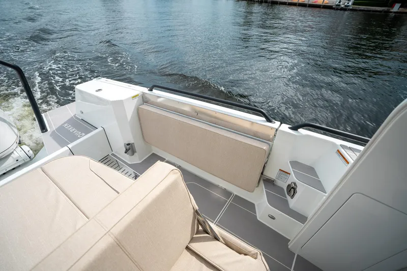 Slide: The Image of 2025 Quarken 35 Sport Tourer boat interior with beige seating and water view. - 25