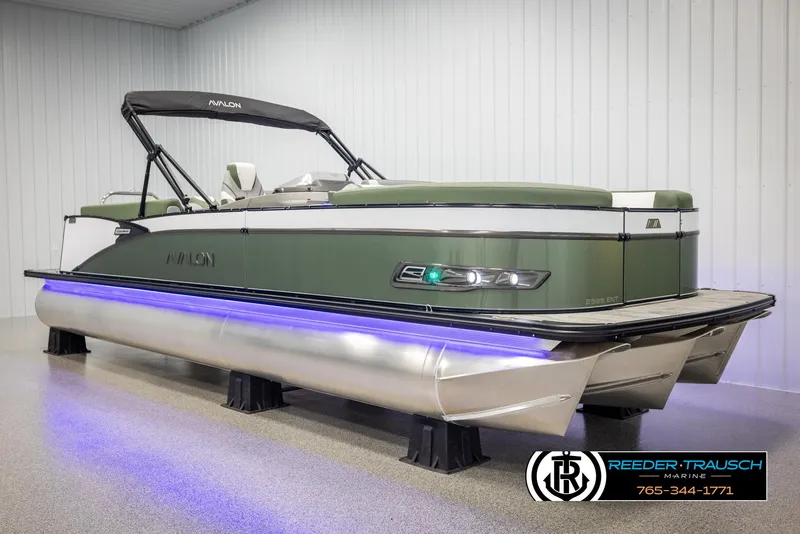 Slide: The Image of 2025 Avalon Catalina Entertainer pontoon boat with green exterior and blue LED lighting. - 2