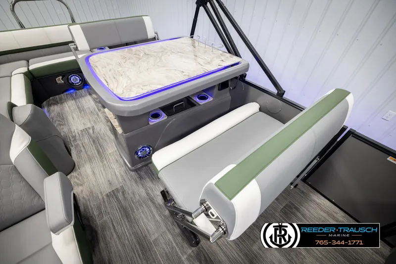 Slide: The Image of 2025 Avalon Catalina Entertainer boat interior with modern seating and illuminated table. - 22