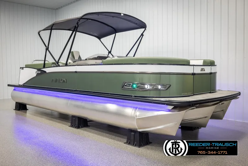 Slide: The Image of 2025 Avalon Catalina Entertainer pontoon boat with canopy and LED lights in showroom. - 3