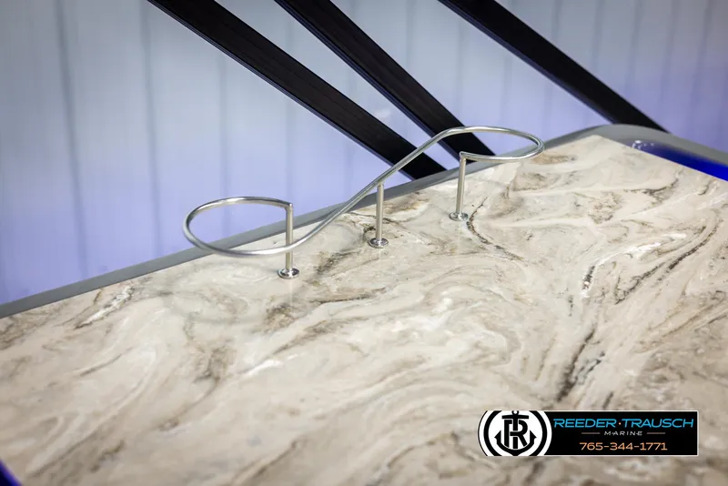 Slide: The Image of 2025 Avalon Catalina Entertainer boat with elegant marble-like countertop and sleek metal railing. - 38