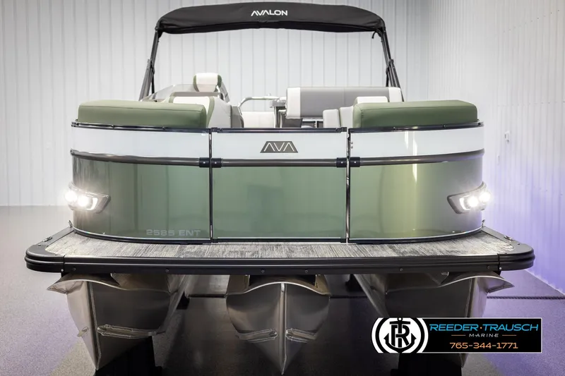 Slide: The Image of 2025 Avalon Catalina Entertainer pontoon boat, green and white, displayed indoors. - 8