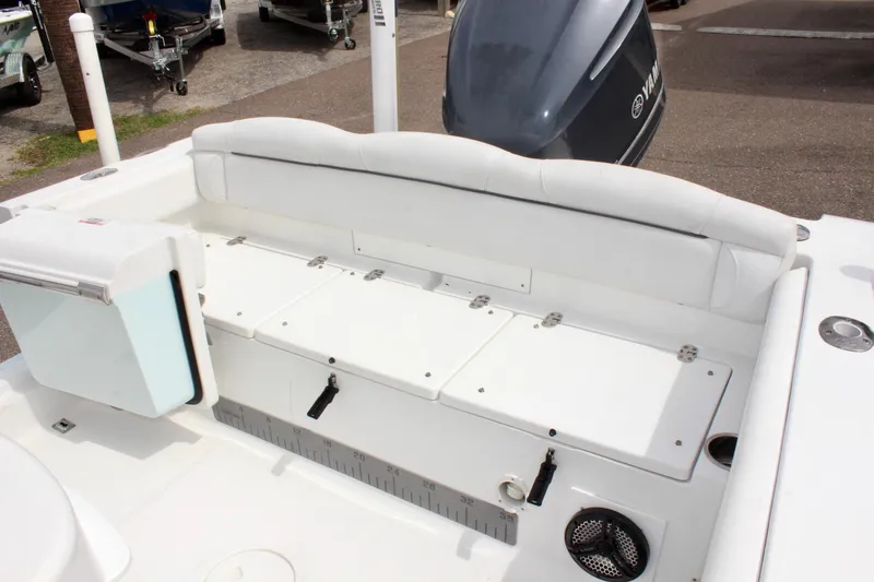 Slide: The Image of 2015 Sea Hunt Ultra 235 SE boat interior with storage compartments and seating. - 10