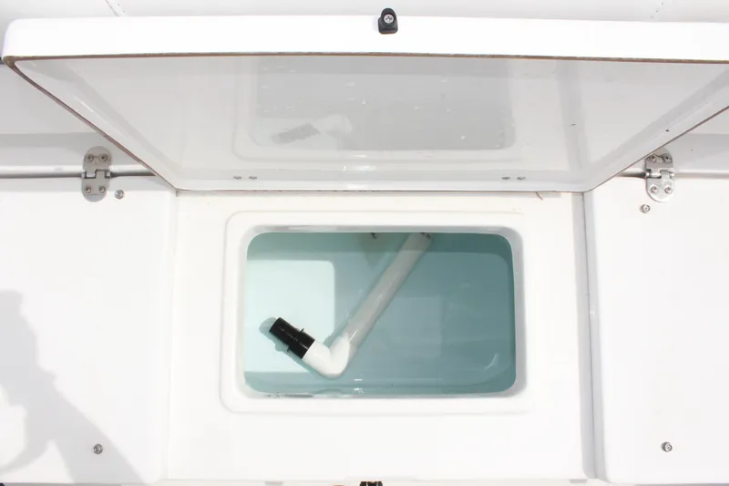Slide: The Image of Open storage compartment on 2015 Sea Hunt Ultra 235 SE boat. - 12