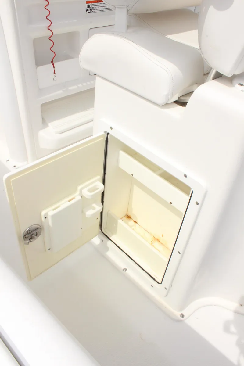 Slide: The Image of Open storage compartment on 2015 Sea Hunt Ultra 235 SE boat. - 14