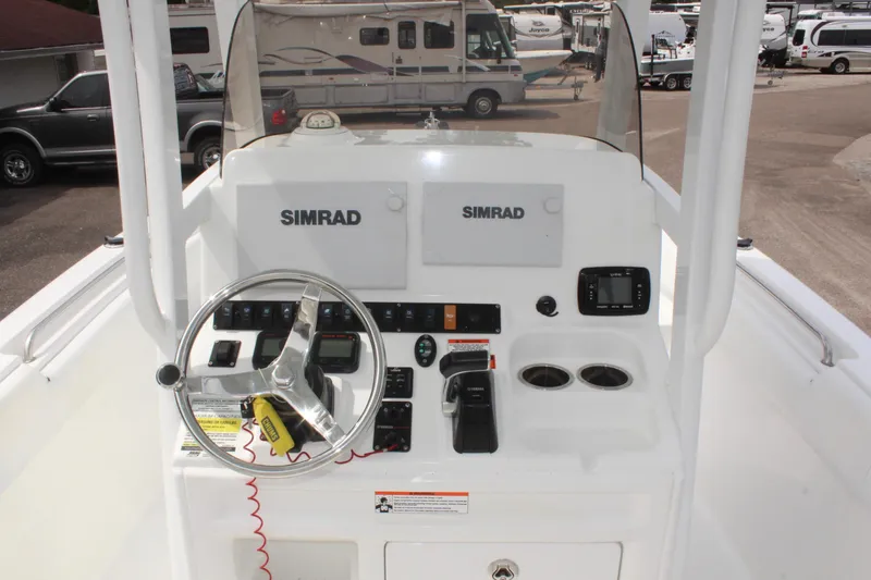Slide: The Image of 2015 Sea Hunt Ultra 235 SE boat console with Simrad electronics and steering wheel. - 17