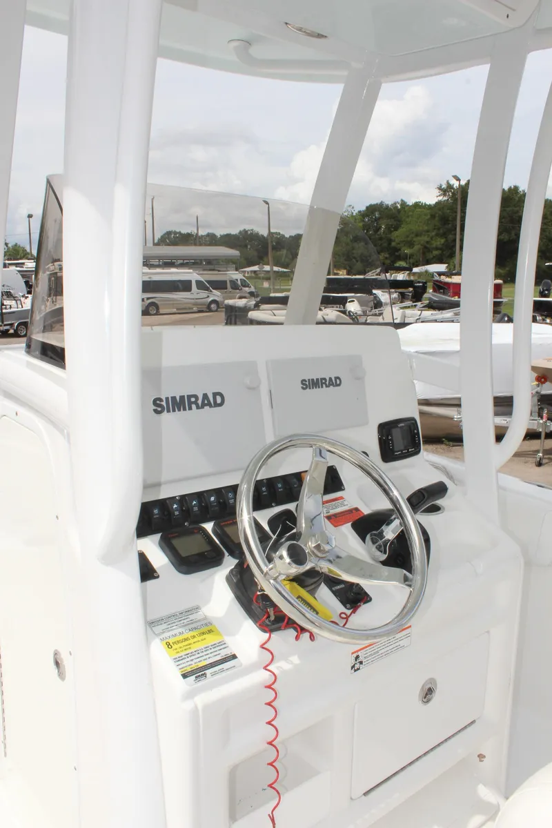 Slide: The Image of 2015 Sea Hunt Ultra 235 SE boat console with Simrad electronics and steering wheel. - 18