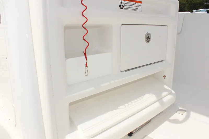 Slide: The Image of 2015 Sea Hunt Ultra 235 SE boat storage compartment with safety features. - 19