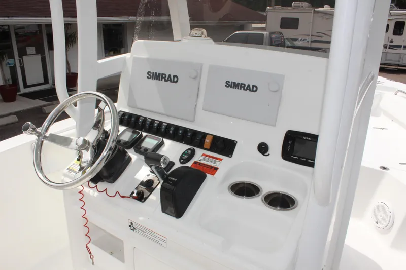 Slide: The Image of Control panel of 2015 Sea Hunt Ultra 235 SE boat with Simrad displays and steering wheel. - 20