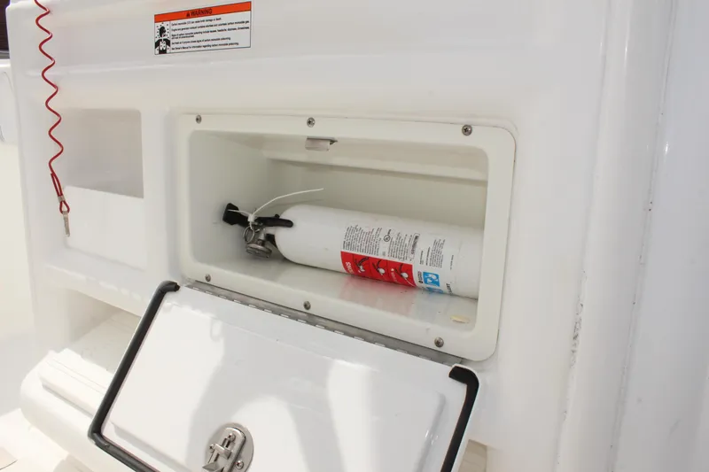 Slide: The Image of Fire extinguisher compartment on 2015 Sea Hunt Ultra 235 SE boat. - 21
