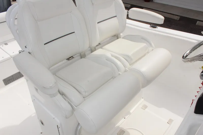 Slide: The Image of 2015 Sea Hunt Ultra 235 SE boat with white cushioned seating. - 23