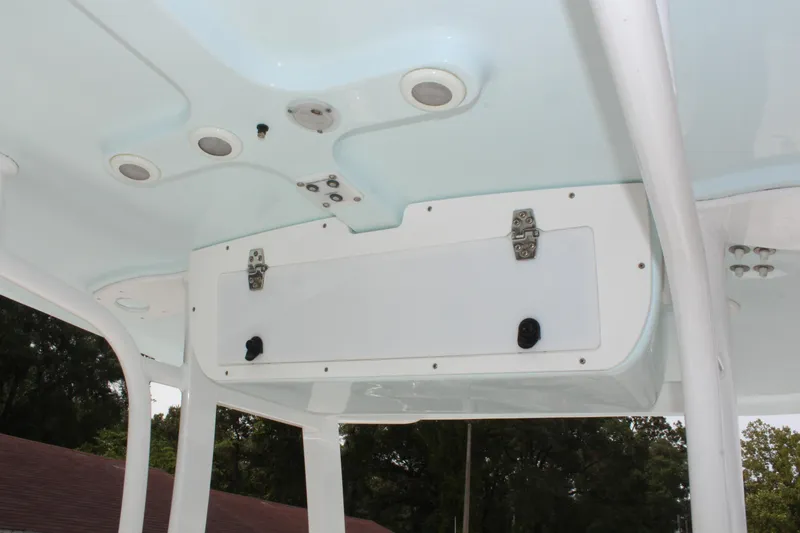Slide: The Image of 2015 Sea Hunt Ultra 235 SE boat interior ceiling with storage compartment and lighting. - 25