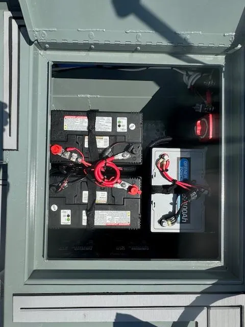 Slide: The Image of Battery compartment of 2025 Custom Ultimate Panfish XL boat, showing multiple connected batteries. - 14