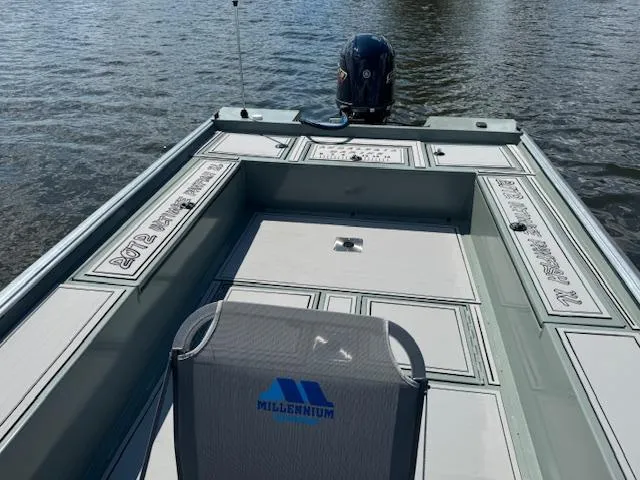 Slide: The Image of Custom Ultimate Panfish XL 2025 boat on water, featuring Millennium seating. - 18