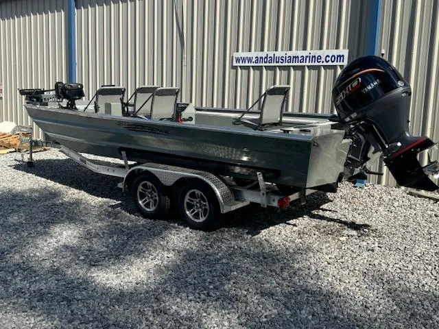 Slide: The Image of 2025 Custom Ultimate Panfish XL boat on trailer, parked on gravel. - 2