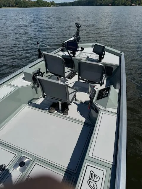 Slide: The Image of Custom Ultimate Panfish XL 2025 boat on a lake, featuring multiple seats and fishing equipment. - 23