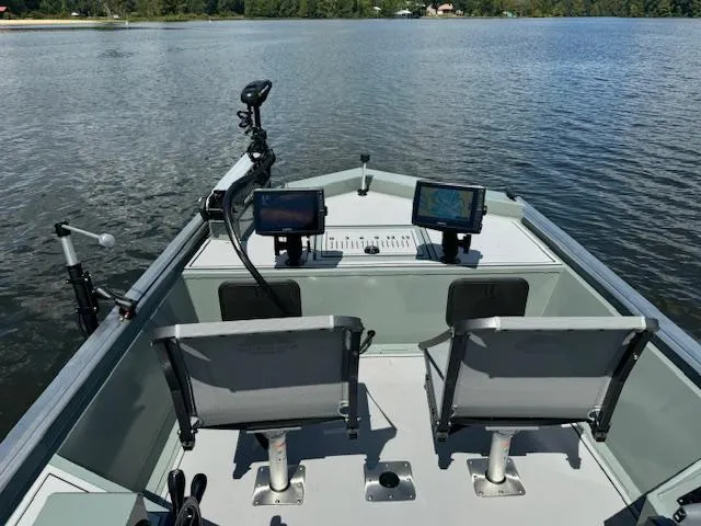 Slide: The Image of Custom Ultimate Panfish XL 2025 boat with dual seats and advanced navigation systems on a lake. - 3