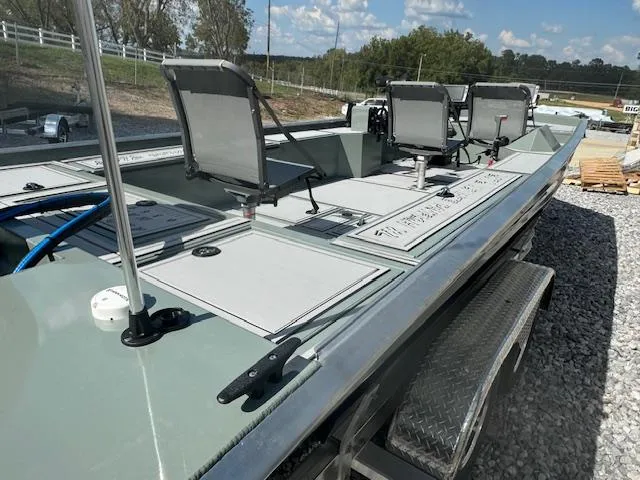 Slide: The Image of Custom Ultimate Panfish XL 2025 boat with seating, on a gravel surface under a clear sky. - 32