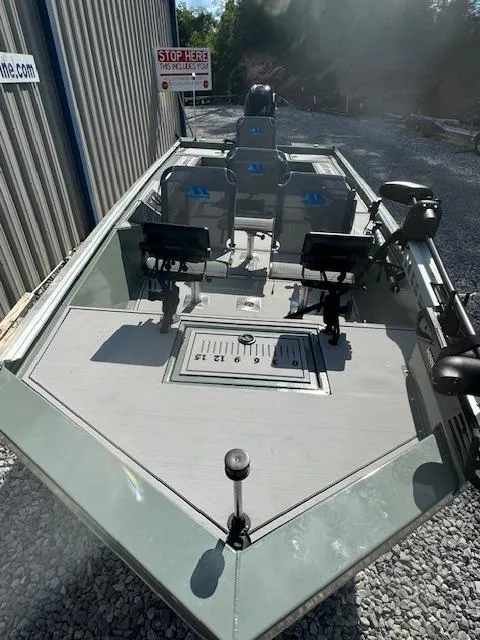 Slide: The Image of 2025 Custom Ultimate Panfish XL boat, equipped for fishing, parked on gravel. - 33