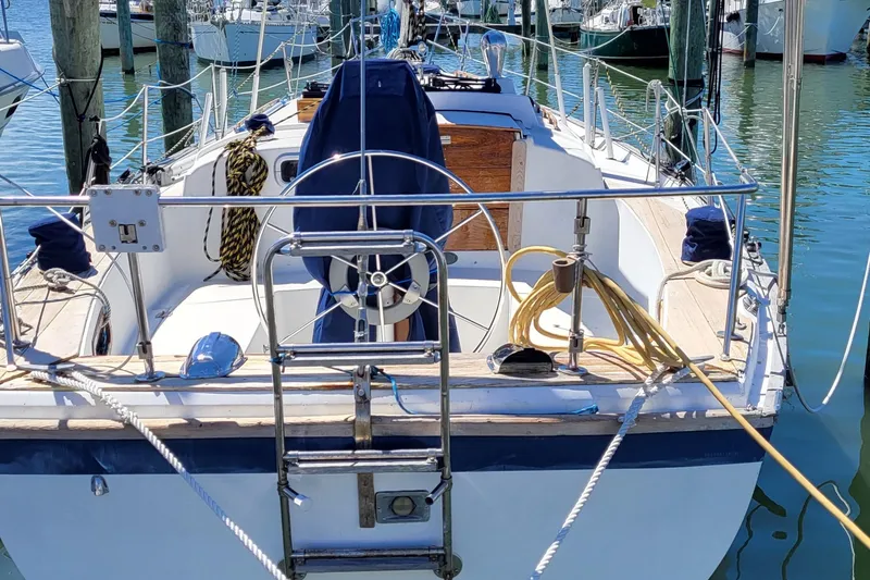 Slide: The Image of 1979 Pearson 365 Sloop sailboat docked, featuring a spacious cockpit and nautical equipment. - 2