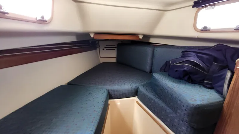 Slide: The Image of Interior cabin of 1979 Pearson 365 Sloop with blue cushions and wooden accents. - 20