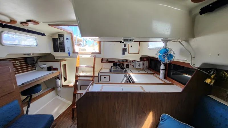 Slide: The Image of Interior of 1979 Pearson 365 Sloop sailboat, featuring kitchen and seating area. - 21